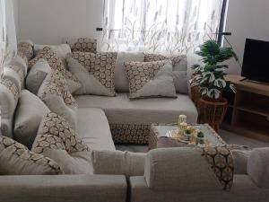 a living room with a large couch with pillows at Sunrise Bay Villa in Mahébourg