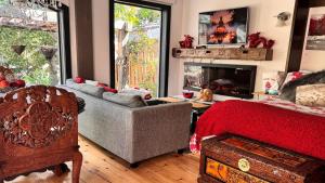 a living room with a couch and a fireplace at Peterborough Zen Retreat in Peterborough