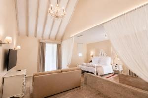 a large bedroom with a bed and a television at Quinta da Maquia Hotel in Sintra