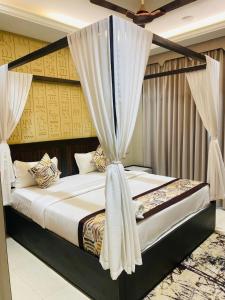a bedroom with a bed with a canopy at StayMooddy in Indore +82 photos