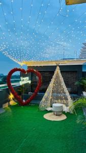 two heart shaped decorations on a building with a bench at StayMooddy in Indore