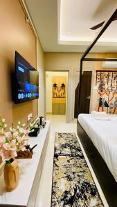 a hotel room with a bed and a tv at StayMooddy in Indore