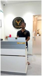 a man standing next to a counter in a room at StayMooddy in Indore