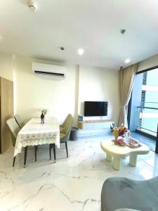 a living room with a table and a tv at Toà gh6 in Gò Công