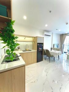 a kitchen with a plant in the middle of a room at Toà gh6 in Gò Công +12 photos