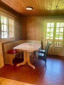 a dining room with a table and two chairs at Chalet Floriana in Les Diablerets
