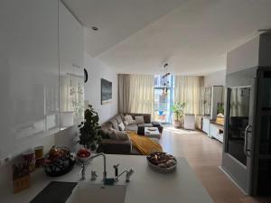 a large kitchen and living room with a couch at Tomorrowland Boom in Boom