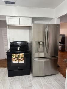 a kitchen with a stainless steel refrigerator and an oven at Rest apartment in Jacksonville