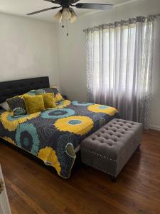 a bedroom with a bed and a ottoman at Rest apartment in Jacksonville