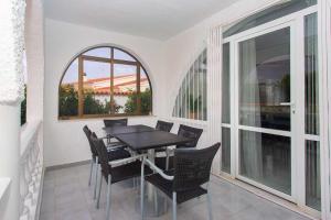 a dining room with a table and chairs on a balcony at CH Villa Mare Ciudad Quesada in Ciudad Quesada