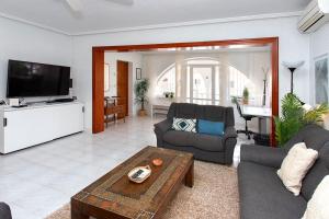 a living room with a couch and a tv at CH Villa Mare Ciudad Quesada in Ciudad Quesada