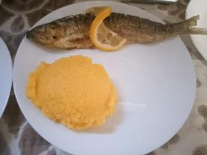 a plate of food with a fish and orange sauce at LEBADA de VARA in Mahmudia +6 photos