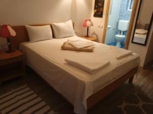 a bed in a bedroom with two towels on it at LEBADA de VARA in Mahmudia