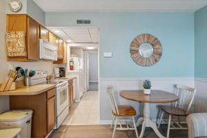 a kitchen with a table and a dining room at 3110 Atlantic Ave, Unit 304 in Wildwood