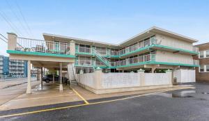 a building with two balconies on top of a parking lot at 3110 Atlantic Ave, Unit 304 in Wildwood