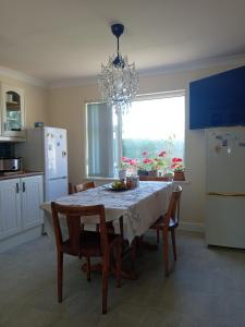 a kitchen with a table with chairs and a chandelier at Sawston Village in Sawston +4 photos