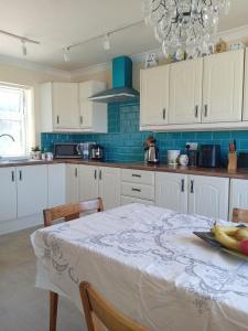 a kitchen with a table with a plate of fruit on it at Sawston Village in Sawston
