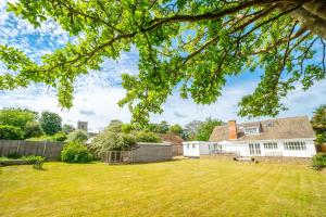 an image of a house with a yard at Flint Cottage, Brancaster in Brancaster