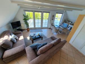 an overhead view of a living room with a large couch at Ruhige, moderne Maisonette Ferienwohnung Rügensonne mit großem Balkon - umgeben vom Wasser in Breege