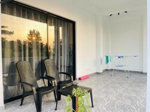 a room with two chairs and a camera at The Ocean Deck Apartments in Moragalla