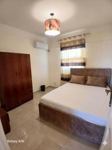 a bedroom with a large bed and a window at dalina resort in El Alamein +6 photos