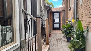 a narrow alley with a door and plants on it at Peterborough Zen Retreat in Peterborough