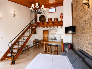 a living room with a staircase and a dining room at Apartamento Cholo in Brañosera