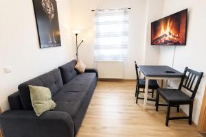 a living room with a couch and a table at Comfortable new Apartment in #Koblenz# direkt am Rhein in Koblenz +5 photos