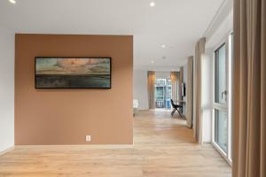 a hallway with a painting hanging on a wall at Skudeløken Apartment Hotel in Førde