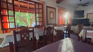 a dining room with tables and chairs and a window at Hotel Marengo in Mina Clavero