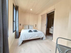 a bedroom with a bed with two hats on it at Filao - Clim Piscine in Auch