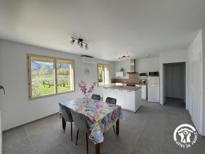 a kitchen and dining room with a table and chairs at Le canigou in Fuilla