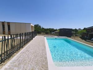 a swimming pool in front of a building at Filao - Clim Piscine in Auch +3 photos