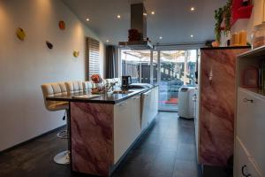 a kitchen with a sink and a counter top at Slapen bij Ticho in Yerseke