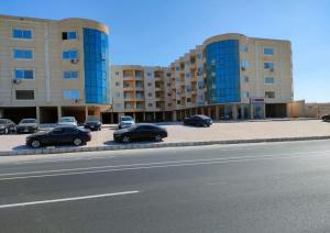 a row of cars parked in a parking lot next to buildings at dalina resort in El Alamein