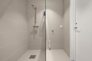 a shower with a glass door in a bathroom at Skudeløken Apartment Hotel in Førde +54 photos