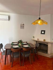 a dining room with a table and chairs and a chandelier at Casa do Rio By Viva a Vida - Alojamentos & Hotels in Constância