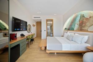 a hotel room with a bed and a desk at Hotel Potami in Himare