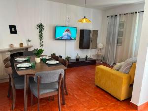 a living room with a table and a yellow couch at Casa do Rio By Viva a Vida - Alojamentos & Hotels in Constância