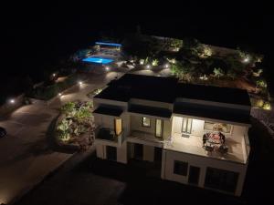 an aerial view of a house at night at Terra Della Salvia Villa with heated pool in Gouves
