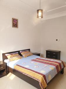 a bedroom with a bed and a chandelier at Modern apartment near Oujda - 80 m² - 8 guests in Oujda