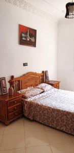 a bedroom with a large bed and two night stands at Modern apartment near Oujda - 80 m² - 8 guests in Oujda