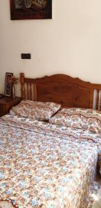 a bed with a floral comforter in a bedroom at Modern apartment near Oujda - 80 m² - 8 guests in Oujda
