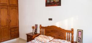 a bedroom with a wooden bed and a wooden cabinet at Modern apartment near Oujda - 80 m² - 8 guests in Oujda