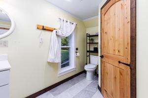 a bathroom with a toilet and a window at The Old Homestead in Roulette +37 photos