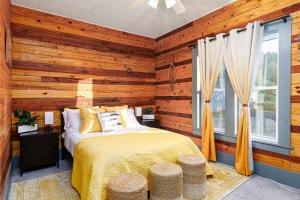 a bedroom with wooden walls and a bed and a window at The Old Homestead in Roulette