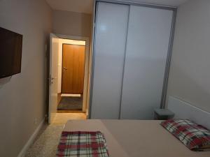 a bedroom with a bed and a door to a hallway at Budva Centar in Budva