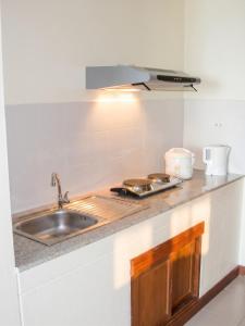 a kitchen counter with a sink and a stove at Cozy apartment in Ko Samui 64 m² with shared pool in Thong Son Beach