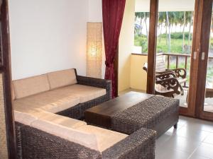 a living room with a couch and a table at Cozy apartment in Ko Samui 64 m² with shared pool in Thong Son Beach