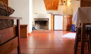 a kitchen with a tile floor with a fireplace at Cosy Apartment Seia 25 m² Fireplace in Seia